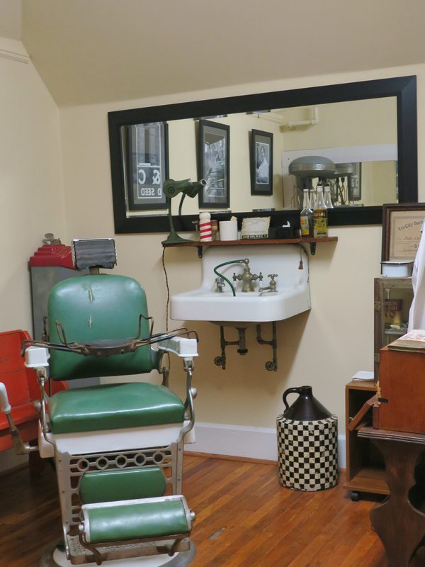 A restored cast-iron barber chair and porcelain basin