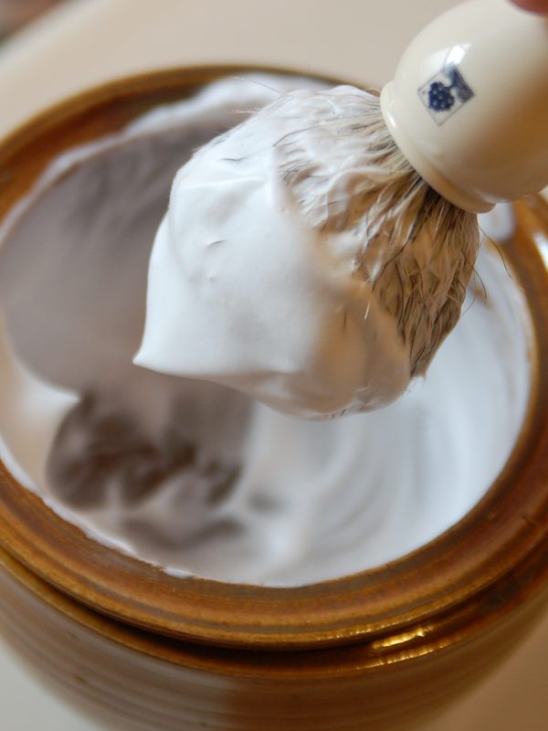 A badger shaving brush loaded with lather