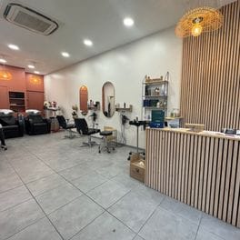 Salon detail: styling chairs and round mirrors along a bright salon floor.