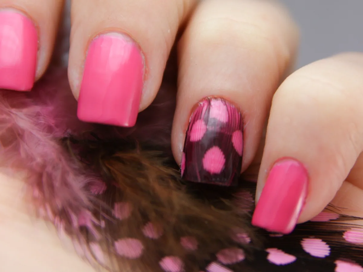 Pink manicure with a single spotted accent nail
