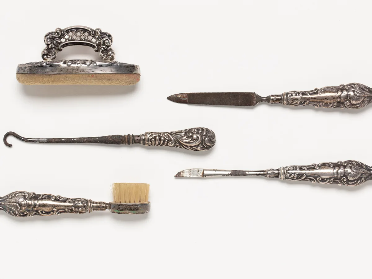 Manicure implements laid out on a clean white work surface