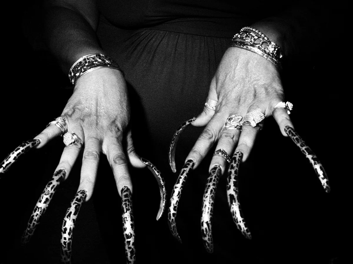 Long decorated statement nails photographed in black and white