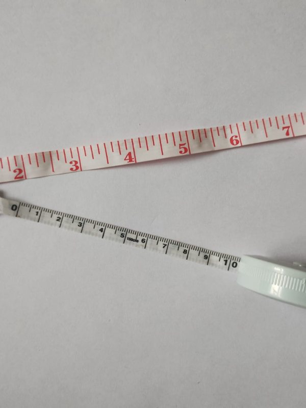 Tailor's measuring tapes hanging together