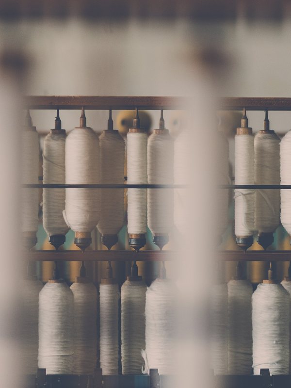Spools of white cotton thread