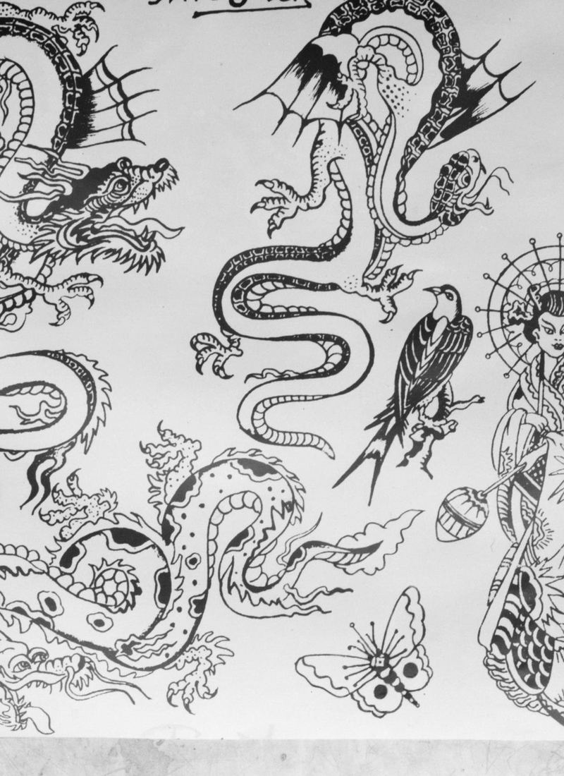 A sheet of flash drawn in ink on paper: dragons and coiled serpents.