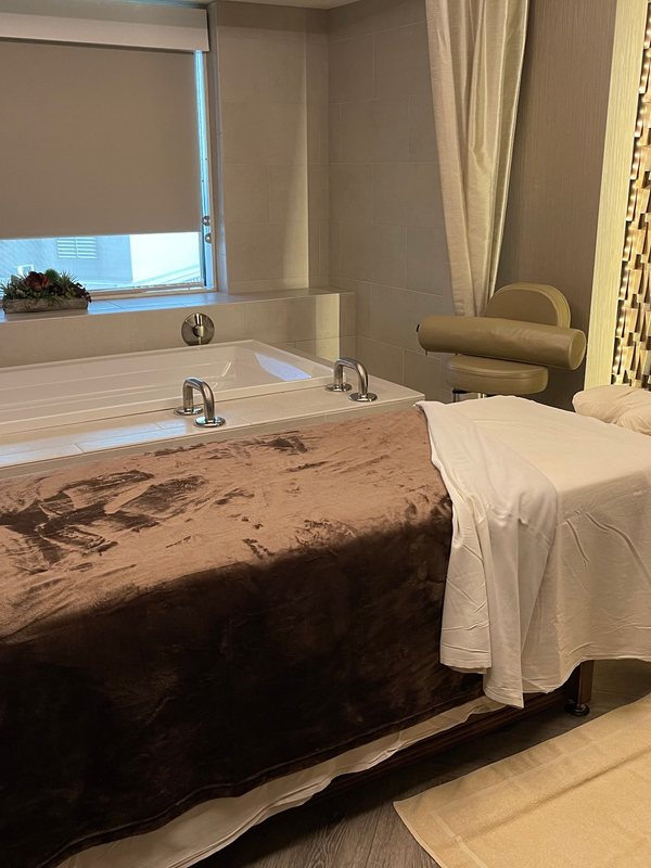 Draped treatment table in the recovery room, folded towels laid out