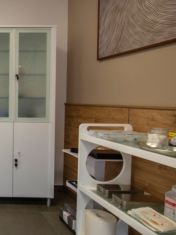 Instrument trolley and glass-fronted cabinet in the preparation room