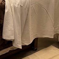 A white sheet draped over a massage table.