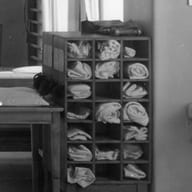 A rack of folded towels in a black-and-white treatment room.