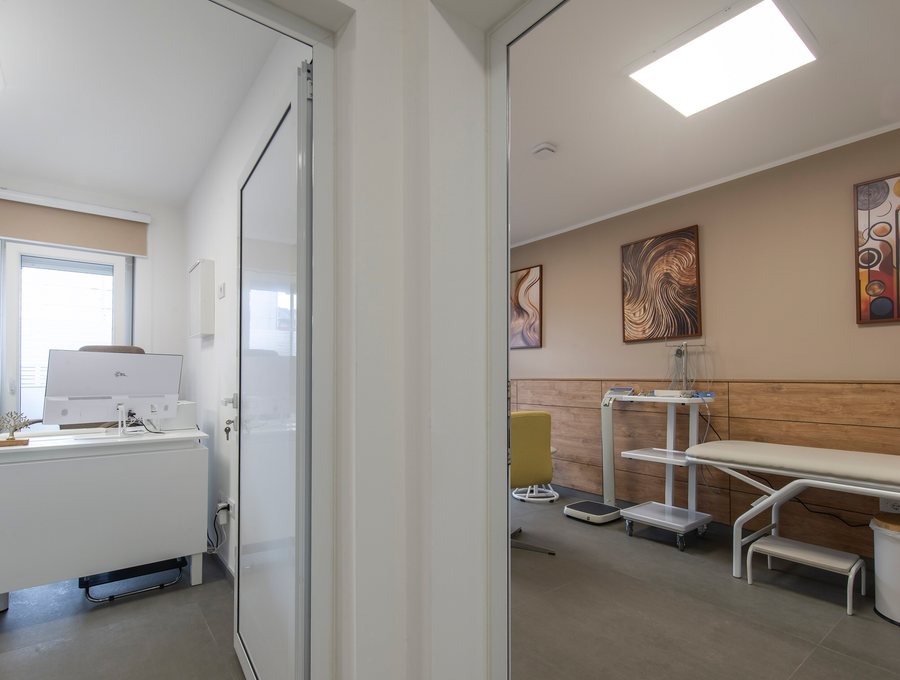 A view through a clinic doorway into a treatment room