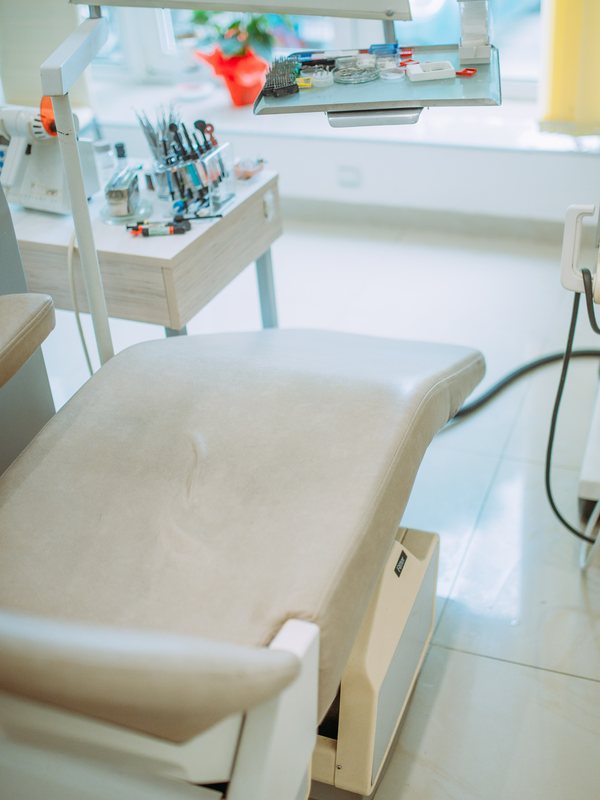 A bright treatment room with the chair reclined