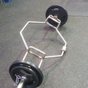 A loaded trap bar resting on the gym floor