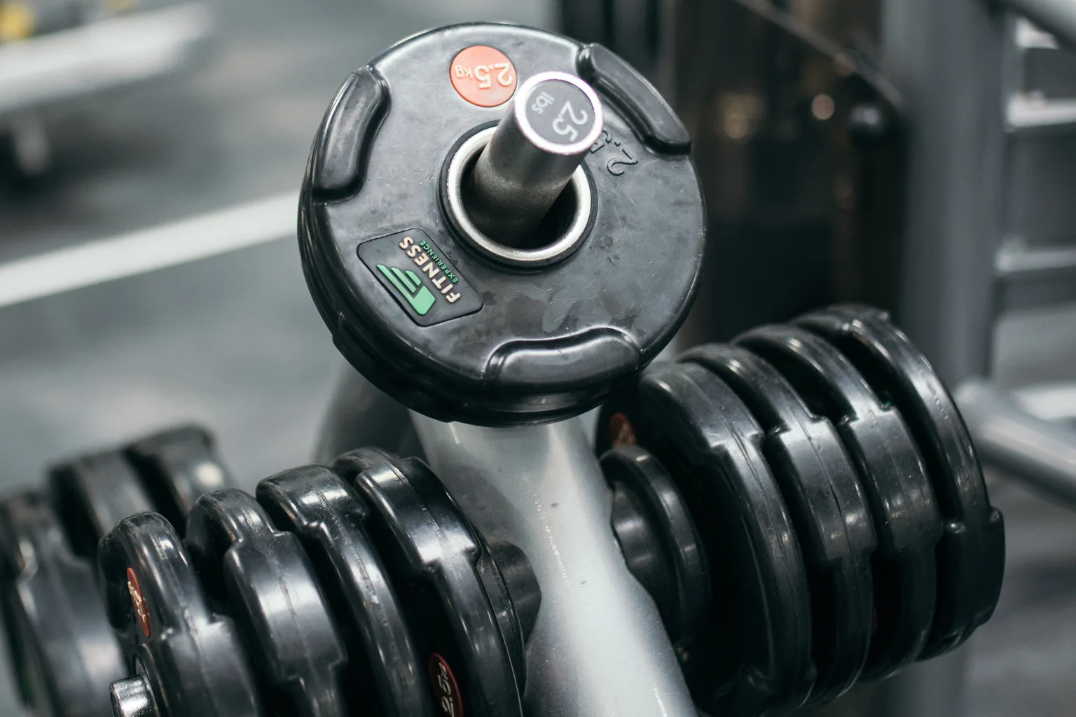 Close view of heavy dumbbells racked on a gym floor