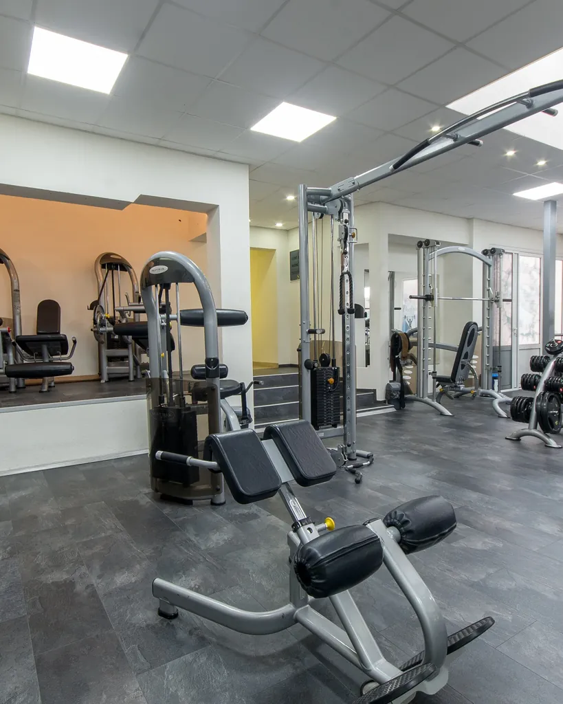 Quiet private training station with a rack, bench and free weights