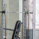 A barbell racked on the guide rails of a squat frame above a bench