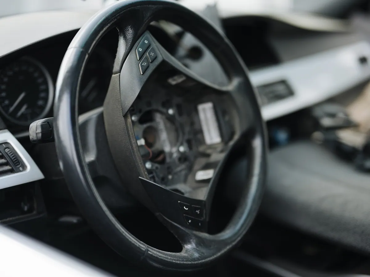 Close view of a steering wheel, column and dashboard after interior work