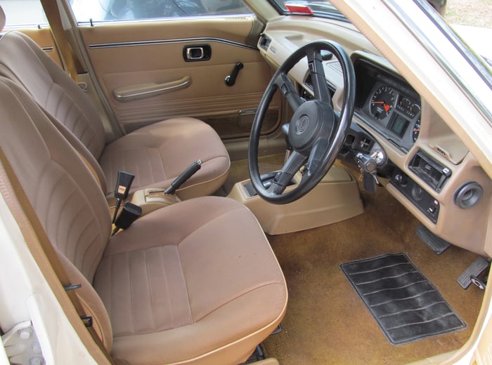 A finished tan cabin: cloth seats, carpet and floor mat cleaned, door card wiped down