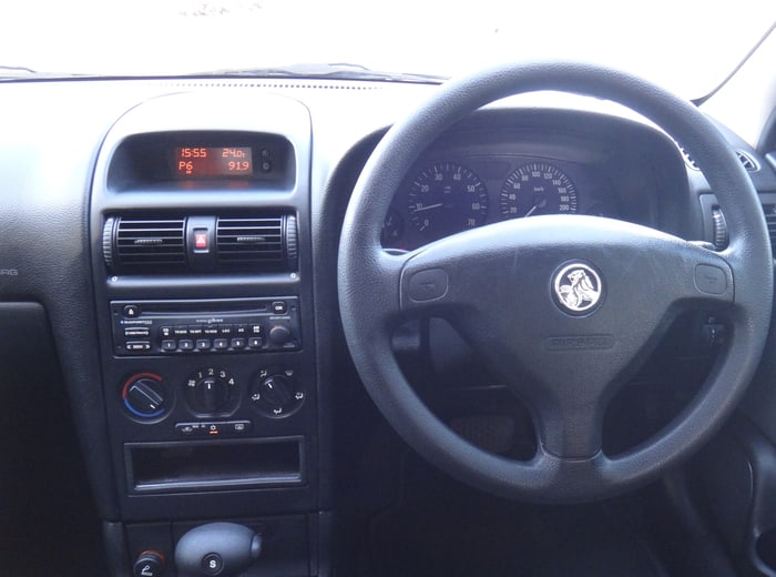 A dressed dashboard and steering wheel, vents and instrument binnacle dust-free
