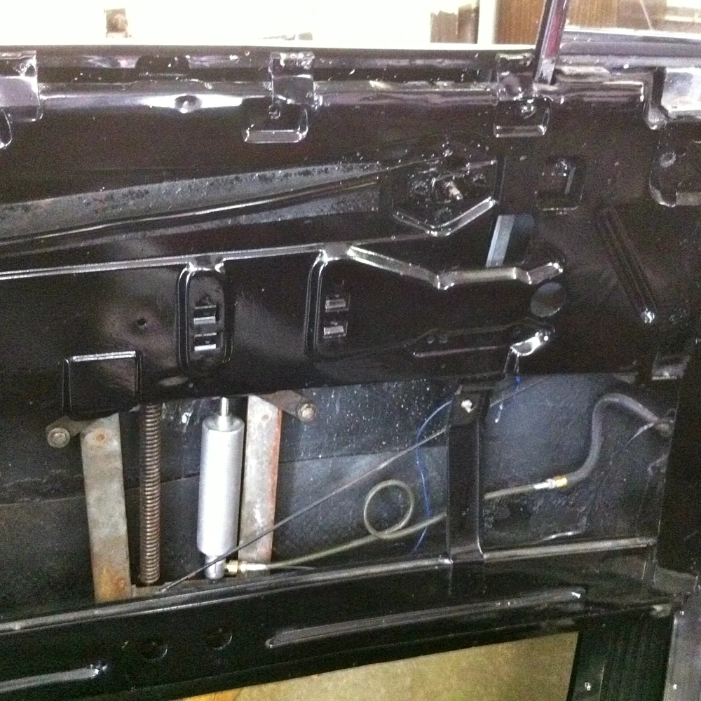 Inside a car door panel showing the window lift mechanism and wiring