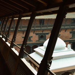 Office detail: a brick courtyard arcade with carved timber above the arches.