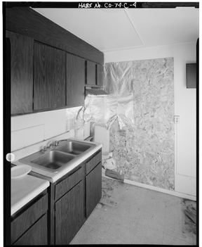 A plain fitted kitchen in a one-bedroom apartment, photographed square on for a survey record. An interior, not a photograph of a member of staff.