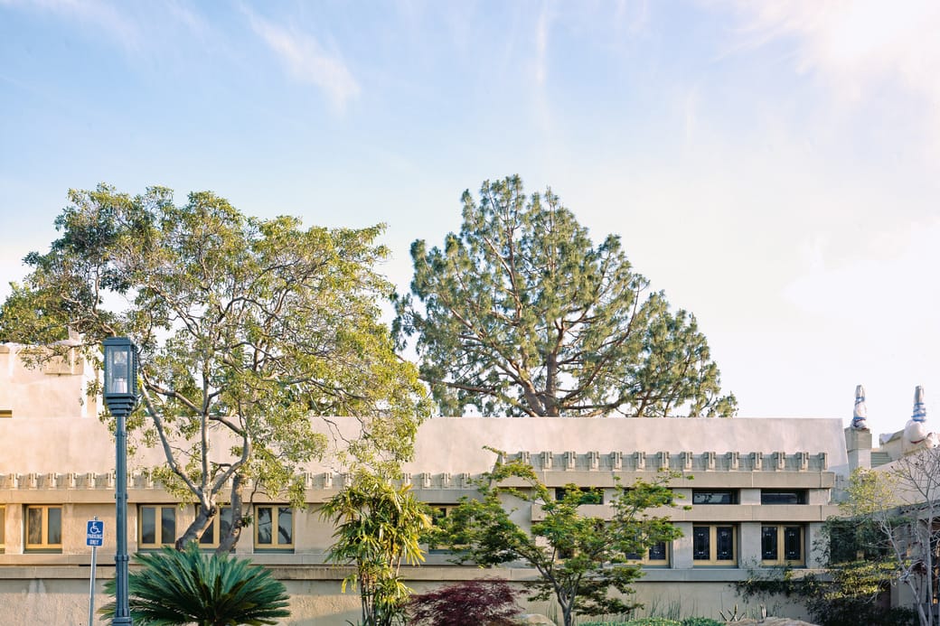 The textured concrete facade and flat roofline of a modernist house.