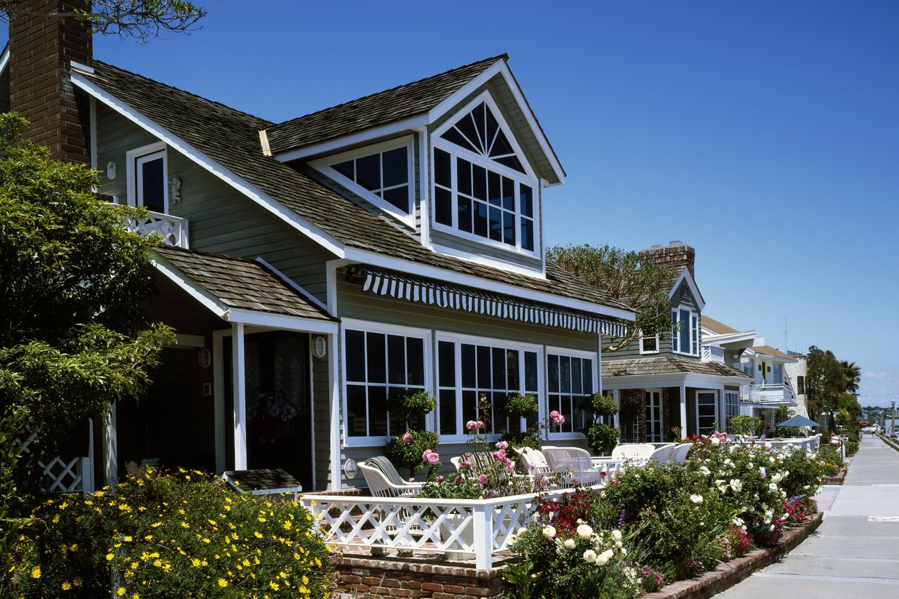 Seagrass Cottage — shingled beach cottage behind a flowering front garden