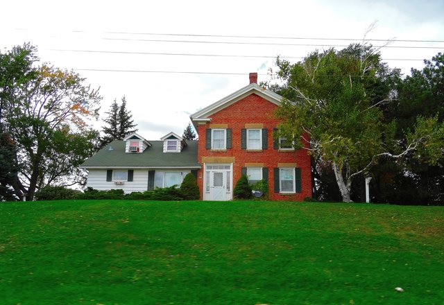 Ferndale Farmhouse — red brick farmhouse with a white clapboard wing above a sloping lawn