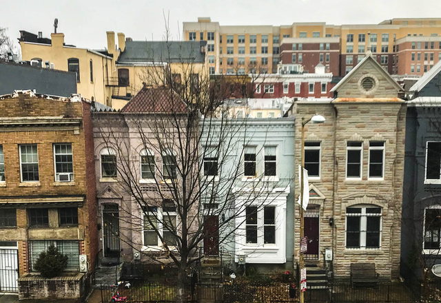 Cobble Court Townhome — brick end-of-row townhouse with a bay window