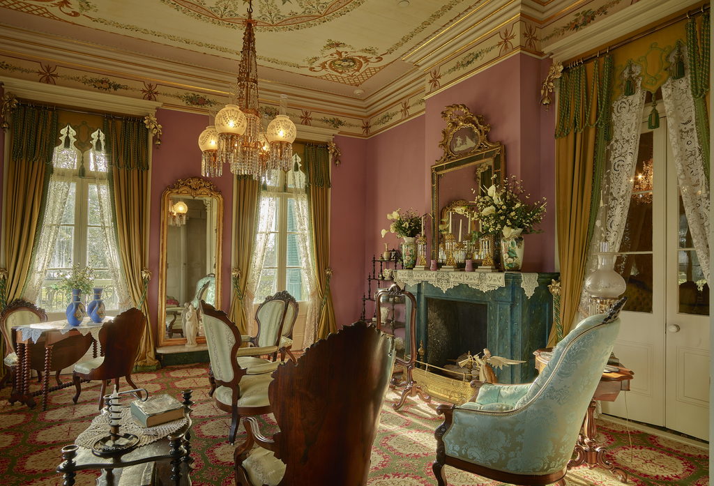 Elegant sitting room with period furniture and tall windows