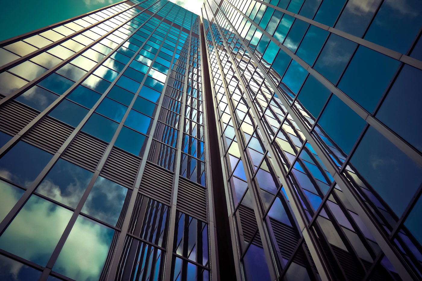 Modern glass-clad office towers against a clear sky