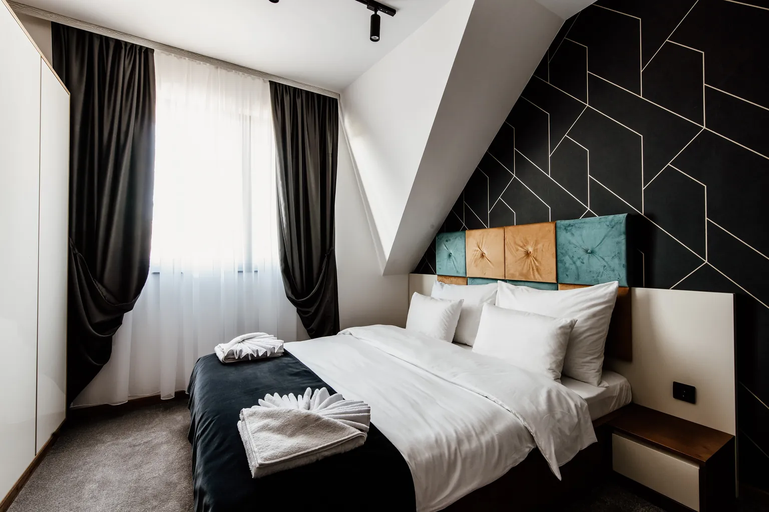 Bedroom with linens made up and bedside surfaces cleared