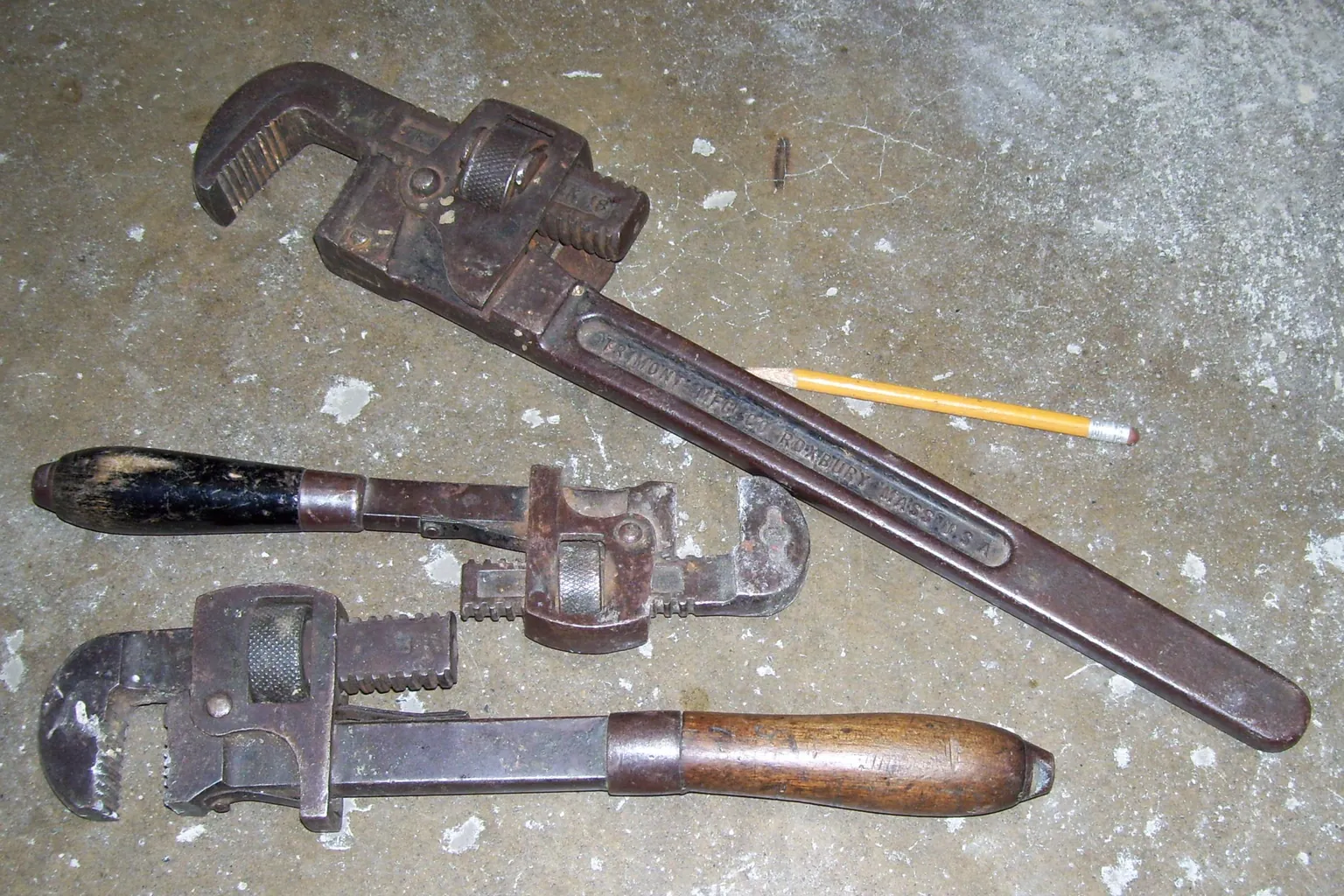 Pipe wrenches staged on a workbench before a scheduled repair visit