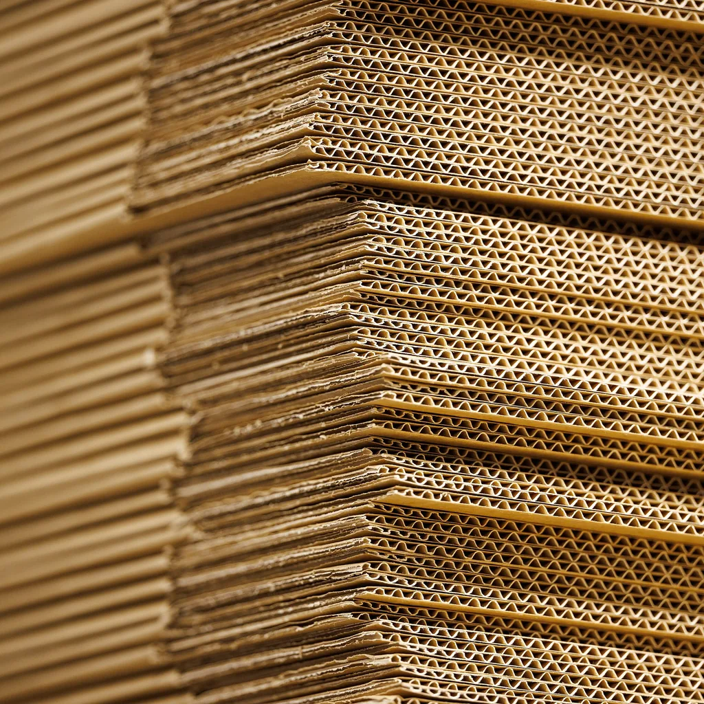 Plain cardboard cartons stacked ready for labelling