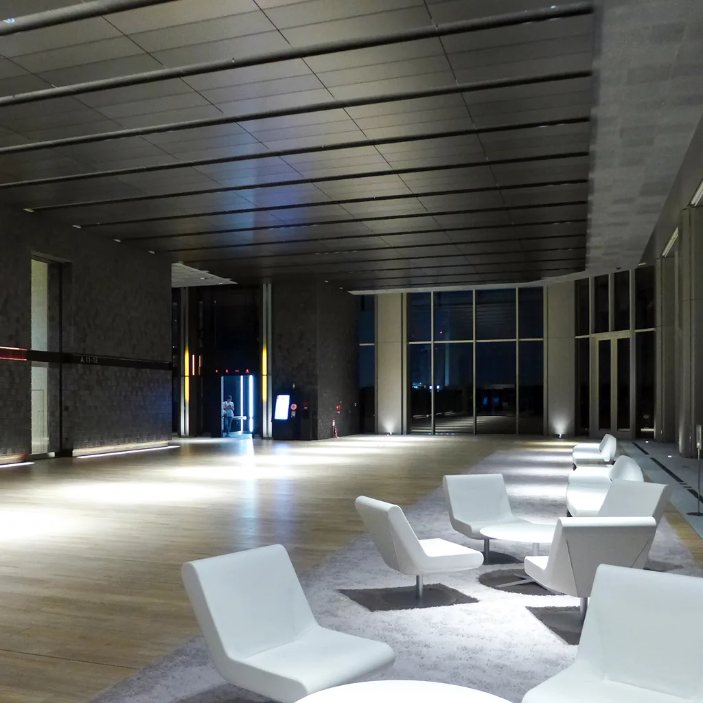 Lounge chairs mark a waiting zone on a cleared office floor.