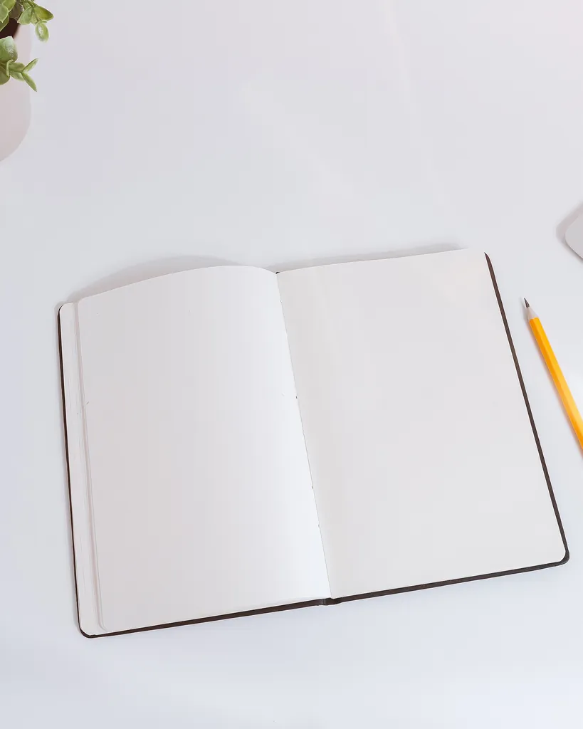 Open notebook and pencil arranged on a planning desk