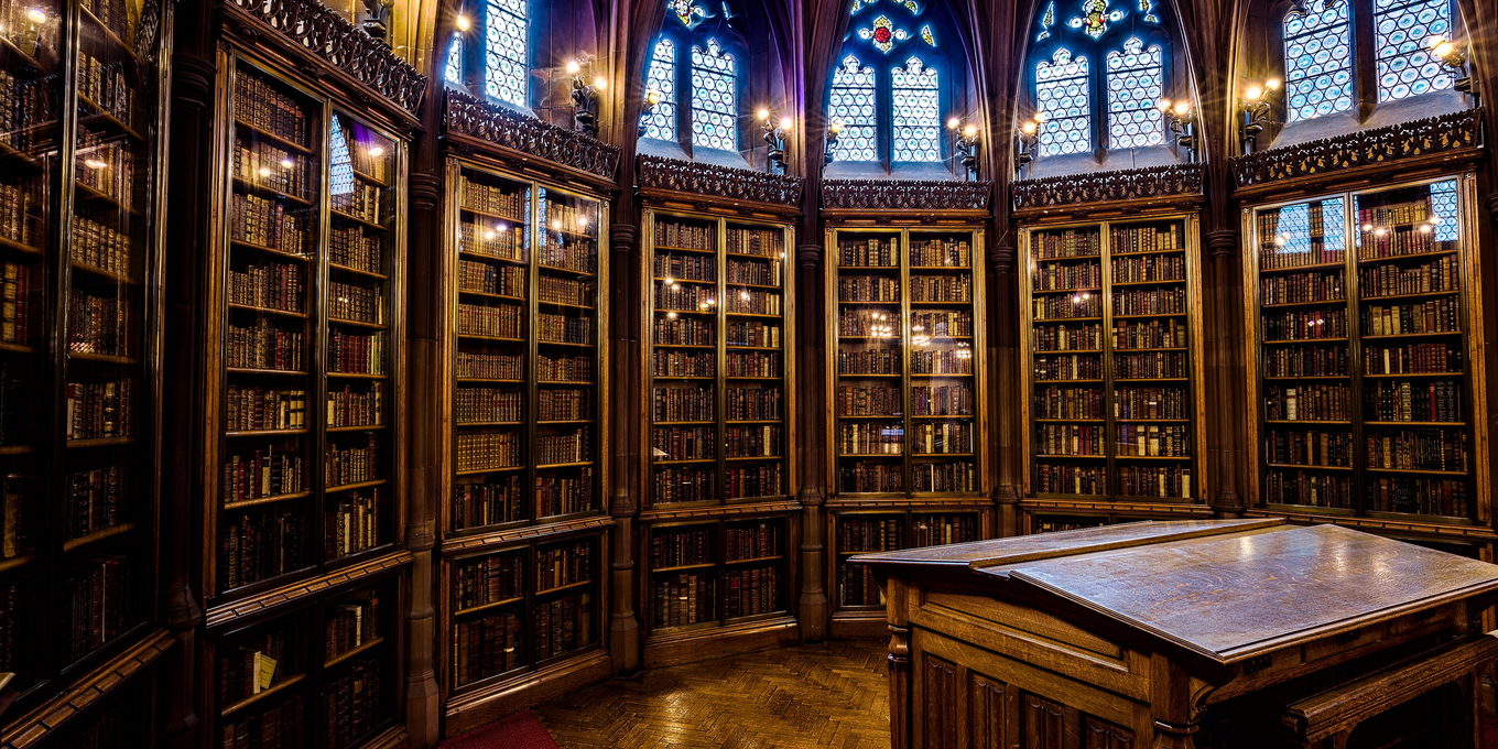 A law library reading room under a vaulted ceiling, with galleries of bound volumes on three sides.