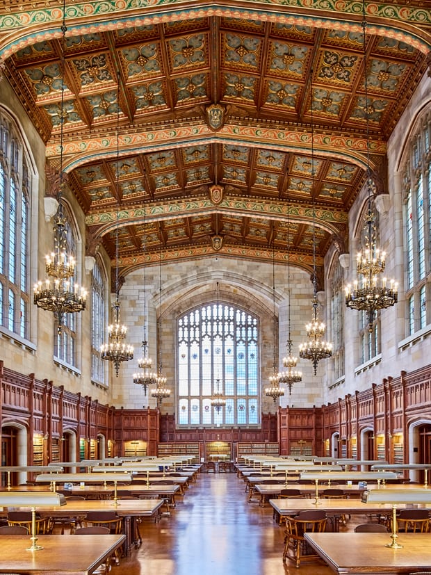Tiered bookcases in a law library, photographed upright from the floor.