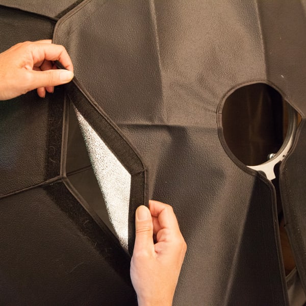 Hands opening the cover of an octabox to reach the speedring inside