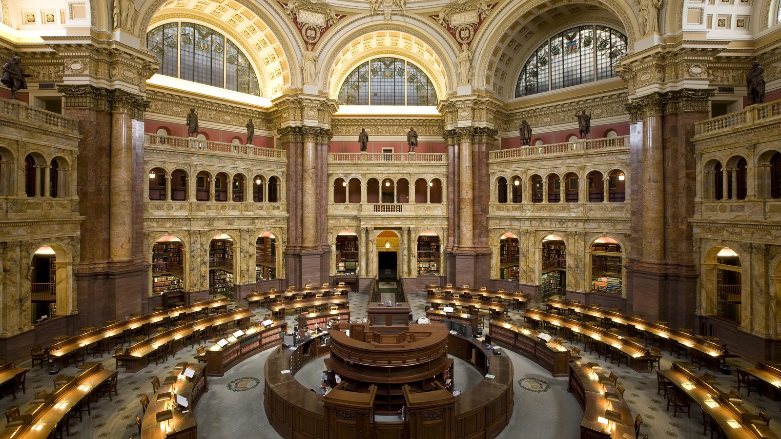 Long reading-room tables where land-use records and survey files are reviewed