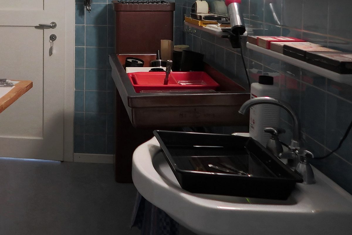 Darkroom sink with developing trays and chemistry