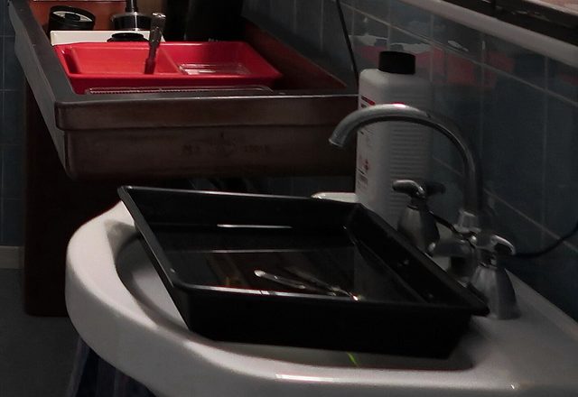 Developing trays beside the darkroom sink