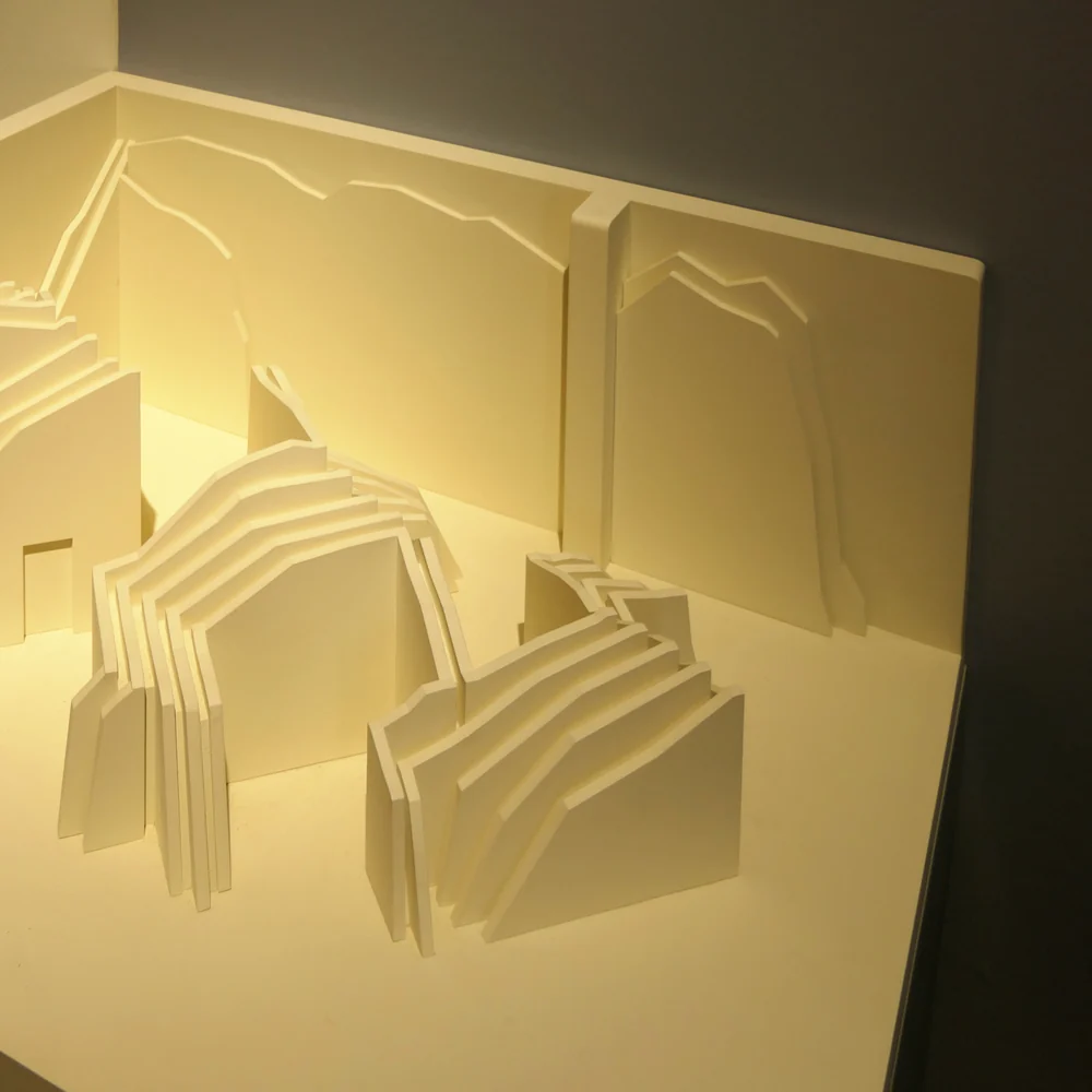 A white paper study model lit from behind