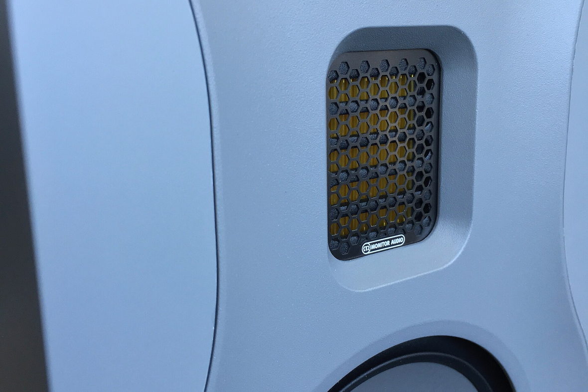 A close view of a studio monitor grille and cabinet.