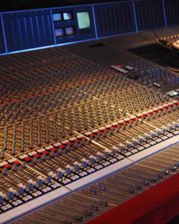 A 72-channel mixing console, faders and channel strips across the desk