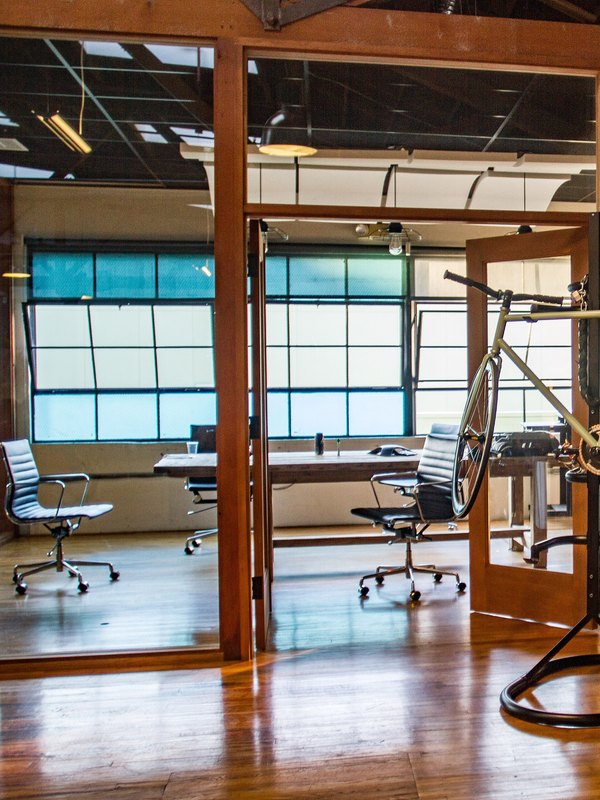 A glass-walled private office off the main floor