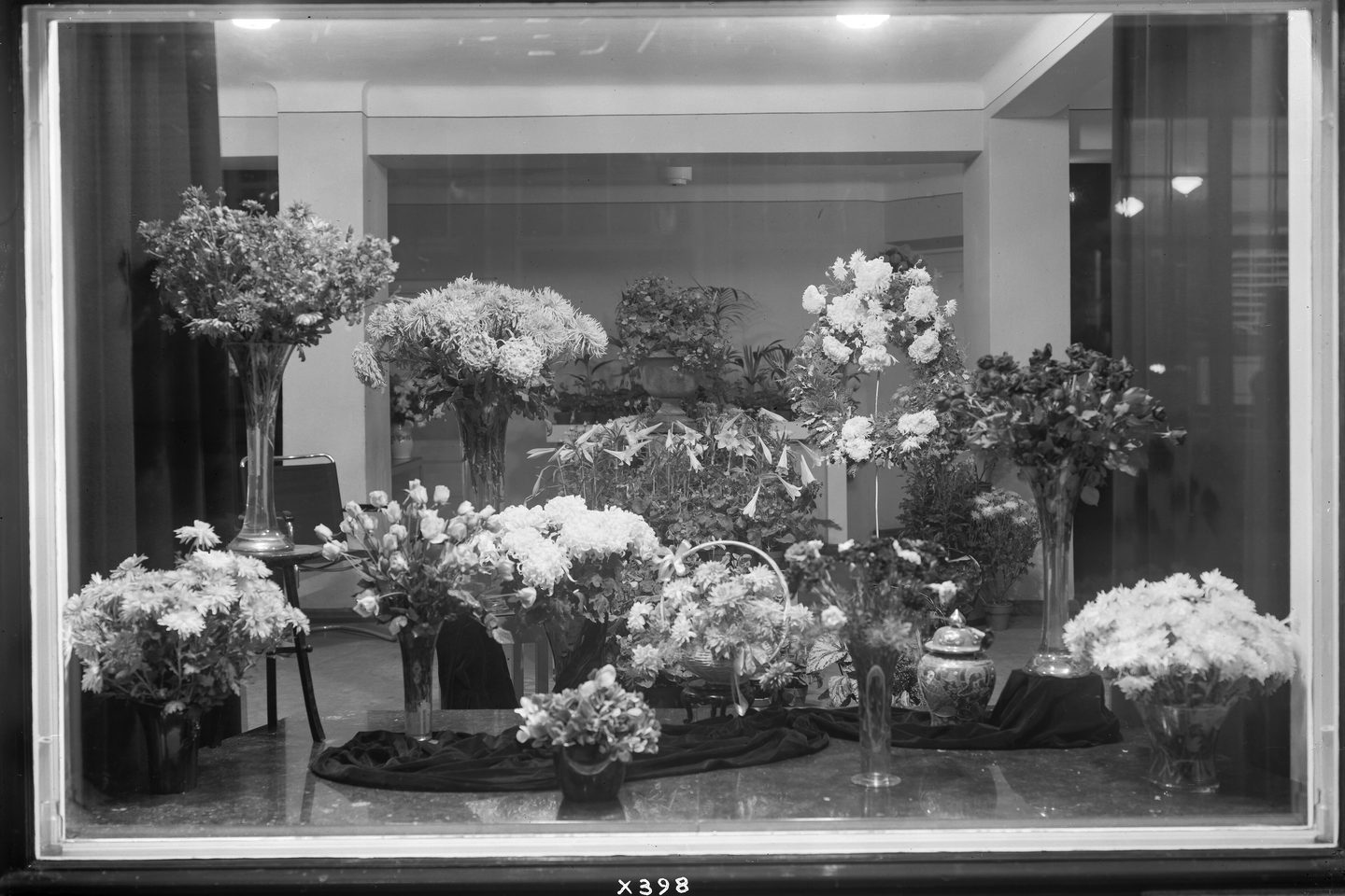 A florist's display window filled with arrangements, 1934.