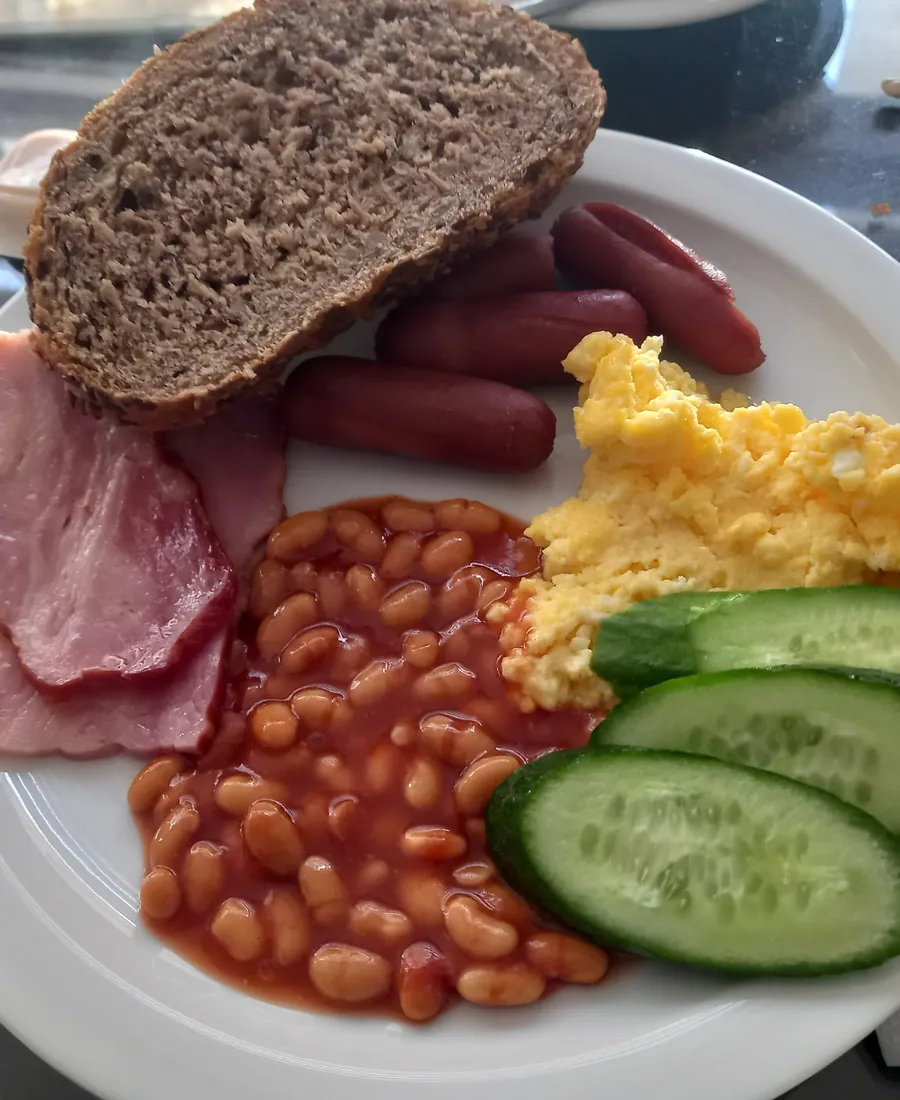 Close view of a cooked breakfast plate with bread and eggs.