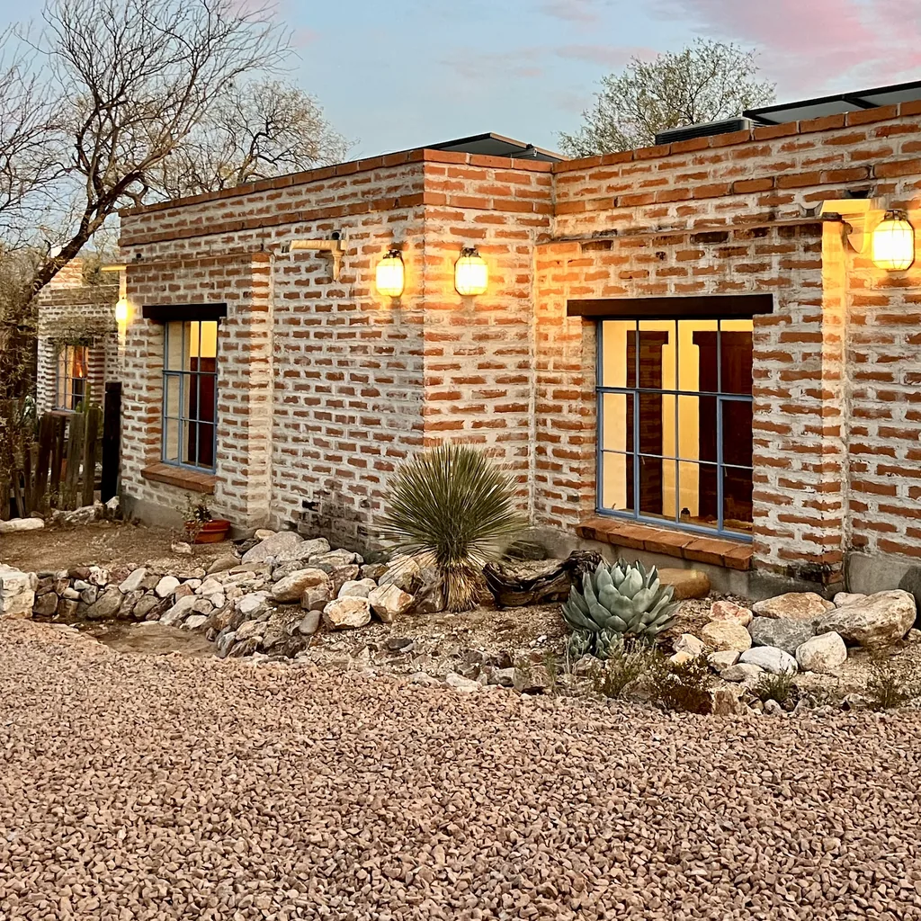 A square crop of the brick facade and agave courtyard.