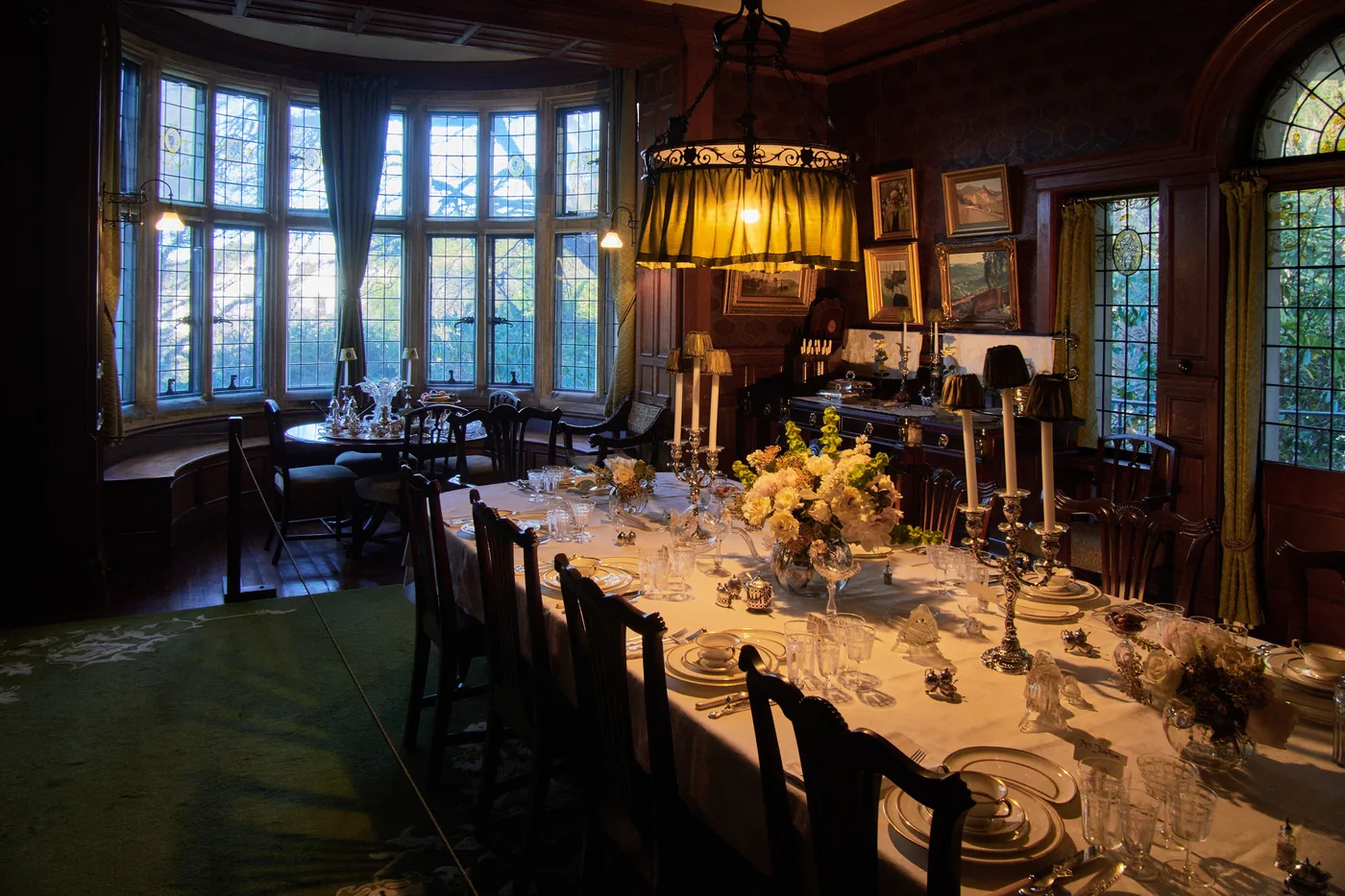 A heritage dining room with a long table laid end to end for a private dinner.